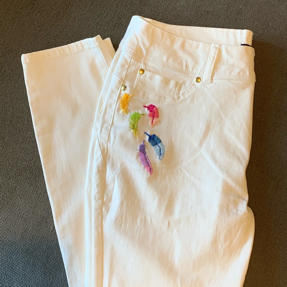 White jeans with hand stitched feathers